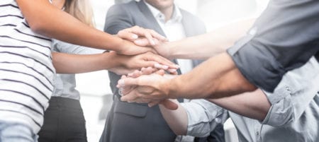 business people high five; team communication strategies